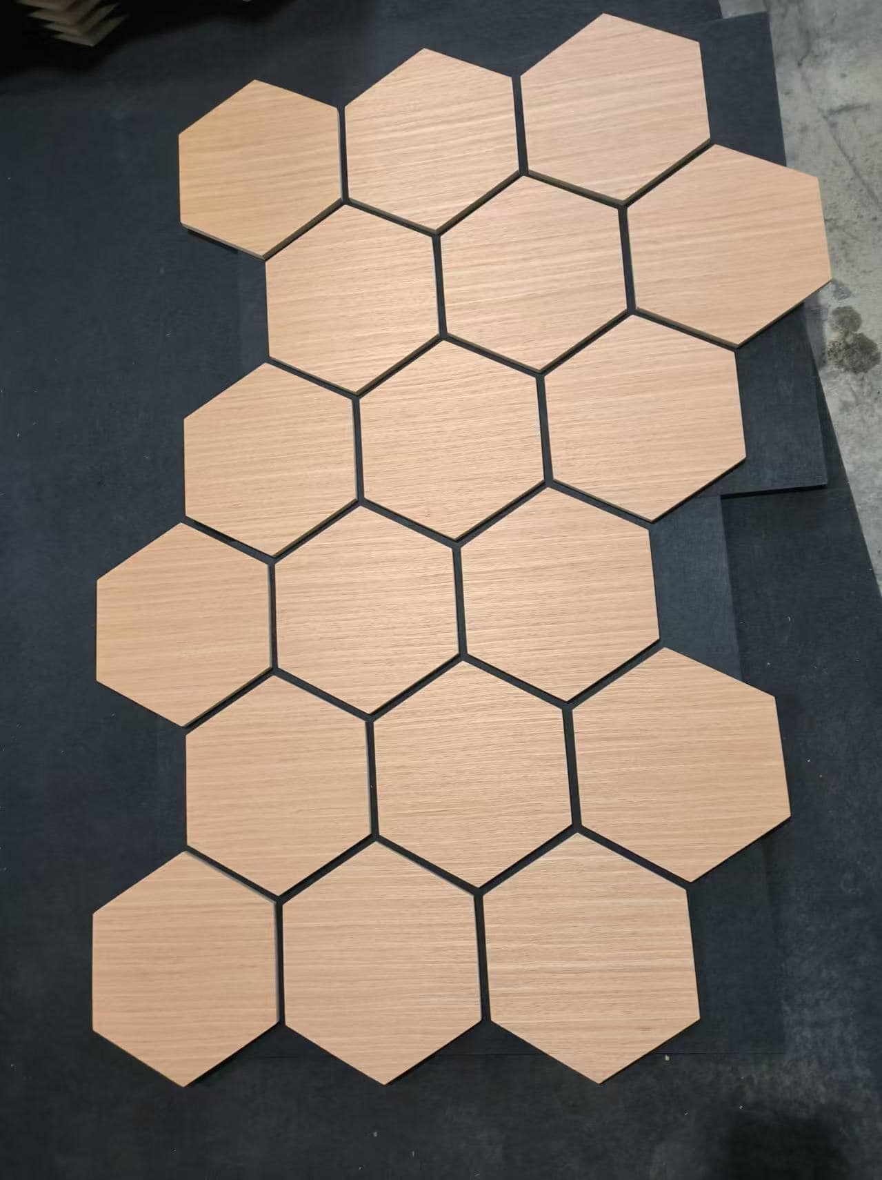 Wood grain hexagonal sound-absorbing panel close-up view